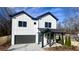 Charming two-story home boasts a modern design with a gray garage door and covered porch at 3128 Cedar St, Scottdale, GA 30079