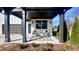 Inviting covered front porch is complete with rocking chairs, side table and manicured landscaping at 3128 Cedar St, Scottdale, GA 30079