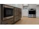 Kitchen island with stainless steel microwave oven, built-in cabinetry, and hardwood floors at 3128 Cedar St, Scottdale, GA 30079