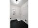 Well-lit laundry room with black tile flooring, wire shelving, and a window for natural light at 3128 Cedar St, Scottdale, GA 30079