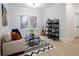 Cozy living room featuring a sofa, modern shelves, and ample natural light at 3128 Cedar St, Scottdale, GA 30079