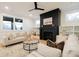 Sun-filled living room features a modern fireplace, built-in shelves, and comfortable seating at 3128 Cedar St, Scottdale, GA 30079