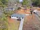 Aerial view of a home showcasing a driveway, well-kept yard, and mature trees surrounding property at 3566 Dorris Cir, Douglasville, GA 30135