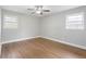 Cozy bedroom featuring hardwood floors, neutral walls, white trim, and ample light at 3566 Dorris Cir, Douglasville, GA 30135