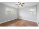 Bright bedroom with hardwood floors, neutral walls, a ceiling fan and large windows at 3566 Dorris Cir, Douglasville, GA 30135