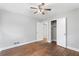 Bright bedroom featuring hardwood floors, closet, neutral walls, and ceiling fan at 3566 Dorris Cir, Douglasville, GA 30135