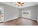 Neutrally decorated bedroom featuring wood-look floors, a ceiling fan and a bright window at 3566 Dorris Cir, Douglasville, GA 30135