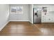 Bright kitchen area with stainless steel refrigerator, white cabinets and hardwood flooring at 3566 Dorris Cir, Douglasville, GA 30135