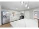 Kitchen featuring stainless steel appliances, white cabinets, and white countertops with pendant lighting at 3566 Dorris Cir, Douglasville, GA 30135