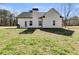 View of the backyard with a white exterior and green lawn at 429 Mulberry Rock Road, Temple, GA 30179