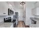 Modern kitchen with white cabinetry, stainless steel appliances, and granite countertops at 429 Mulberry Rock Road, Temple, GA 30179