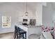 Kitchen featuring white cabinets, stainless steel appliances, bar seating, and a view into the living area at 429 Mulberry Rock Road, Temple, GA 30179