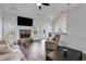 Bright living room with a stone fireplace, vaulted ceiling, and views of the kitchen and backyard at 429 Mulberry Rock Road, Temple, GA 30179