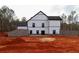 Spacious backyard featuring a modern farmhouse with white siding and black framed windows at 472 Price Rd, Carrollton, GA 30116