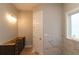 Bathroom featuring light fixtures and dark cabinets with a white door at 472 Price Rd, Carrollton, GA 30116