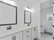 Bathroom with dual vanity, modern black fixtures, white cabinets, and a glimpse of a separate toilet area at 472 Price Rd, Carrollton, GA 30116