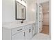 Modern bathroom featuring a glass enclosed shower and a vanity with black fixtures and white cabinets at 472 Price Rd, Carrollton, GA 30116