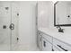 Modern bathroom featuring a glass enclosed shower and a vanity with black fixtures and white cabinets at 472 Price Rd, Carrollton, GA 30116