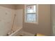 Bathroom featuring tub, window and awaiting finishing touches at 472 Price Rd, Carrollton, GA 30116