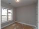 Empty bedroom featuring a bright window, fresh paint, and a doorway to another room in a staged home at 472 Price Rd, Carrollton, GA 30116