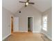 Bright bedroom with vaulted ceiling, fan, and doorways to closets/bathrooms at 472 Price Rd, Carrollton, GA 30116