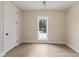 Minimalist bedroom with a view of outdoor lounge chairs through a bright window, showcasing clean lines at 472 Price Rd, Carrollton, GA 30116