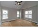 Bedroom featuring three large windows and a ceiling fan at 472 Price Rd, Carrollton, GA 30116