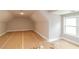 Bright bonus room featuring angled ceiling and window providing natural light at 472 Price Rd, Carrollton, GA 30116