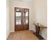 Inviting entryway with wood flooring, stylish console table and glass panel entry door at 472 Price Rd, Carrollton, GA 30116