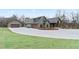 View of custom-built home featuring an attached two-car garage and a detached two-car garage and circular driveway at 472 Price Rd, Carrollton, GA 30116