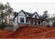 Elegant farmhouse with a welcoming porch, combining classic design with modern elements at 472 Price Rd, Carrollton, GA 30116