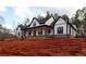 Eye-catching farmhouse featuring a covered porch with wood columns, contrasted by its white and black design at 472 Price Rd, Carrollton, GA 30116