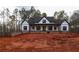 Charming two-story farmhouse with black framed windows and a welcoming covered porch at 472 Price Rd, Carrollton, GA 30116