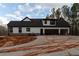 Attached two-car garage with concrete driveway complementing this charming white and black farmhouse at 472 Price Rd, Carrollton, GA 30116