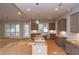 A well-lit kitchen featuring modern cabinets, a spacious island, and natural light streaming through windows and a door at 472 Price Rd, Carrollton, GA 30116