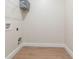 Unfinished laundry room with basic utility hookups, shelving and wood-look flooring ready for customization at 472 Price Rd, Carrollton, GA 30116
