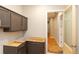 A new laundry room with dark cabinets above a washer/dryer with a door to the hallway at 472 Price Rd, Carrollton, GA 30116