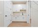 Mudroom with shaker cabinets, granite countertop, sink and wire shelving leading to closet area at 472 Price Rd, Carrollton, GA 30116
