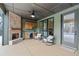 Inviting outdoor living space featuring a brick fireplace and comfortable seating area with wet bar at 472 Price Rd, Carrollton, GA 30116