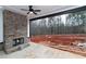 Covered patio features brick fireplace and a view of a forest at 472 Price Rd, Carrollton, GA 30116