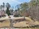 Aerial view of an estate home featuring landscaping, mature trees and water feature at 11180 West Rd, Roswell, GA 30075
