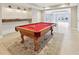 Basement with pool table on decorative rug and adjacent wet bar at 11180 West Rd, Roswell, GA 30075