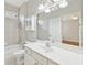 Bright bathroom with a large vanity, shower-tub combo, and natural light at 11180 West Rd, Roswell, GA 30075