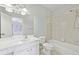 En-suite bathroom featuring a shower-tub combo and large vanity with a view to the main bedroom at 11180 West Rd, Roswell, GA 30075