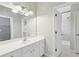 Bright bathroom with white vanity, large mirror, and combined shower and tub at 11180 West Rd, Roswell, GA 30075