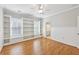 Charming bedroom features hardwood floors, built-in shelves, and a view to the en-suite bathroom at 11180 West Rd, Roswell, GA 30075