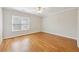 Bedroom showcasing hardwood floors and natural light through a window with blinds at 11180 West Rd, Roswell, GA 30075