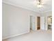 Bright bedroom with a view to the en-suite and walk-in closet at 11180 West Rd, Roswell, GA 30075