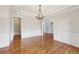 Dining room featuring hardwood floors, wainscoting, trey ceiling, and chandelier at 11180 West Rd, Roswell, GA 30075