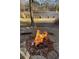 Outdoor fire pit with stone surround, offering a relaxing space near the water at 11180 West Rd, Roswell, GA 30075